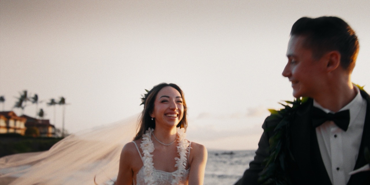 Madison and Brandon laugh together during their intimate oceanfront wedding dinner at Four Seasons Maui
