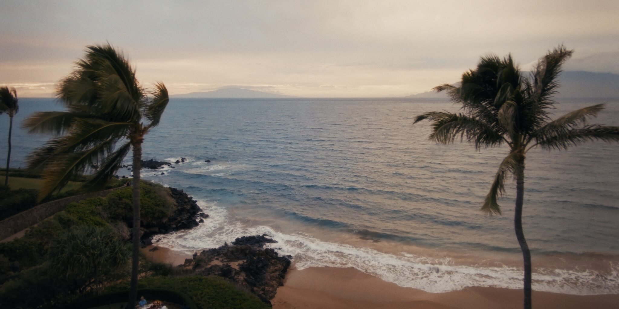 Soft evening light over the palms, beach, and Pacific at Four Seasons Maui