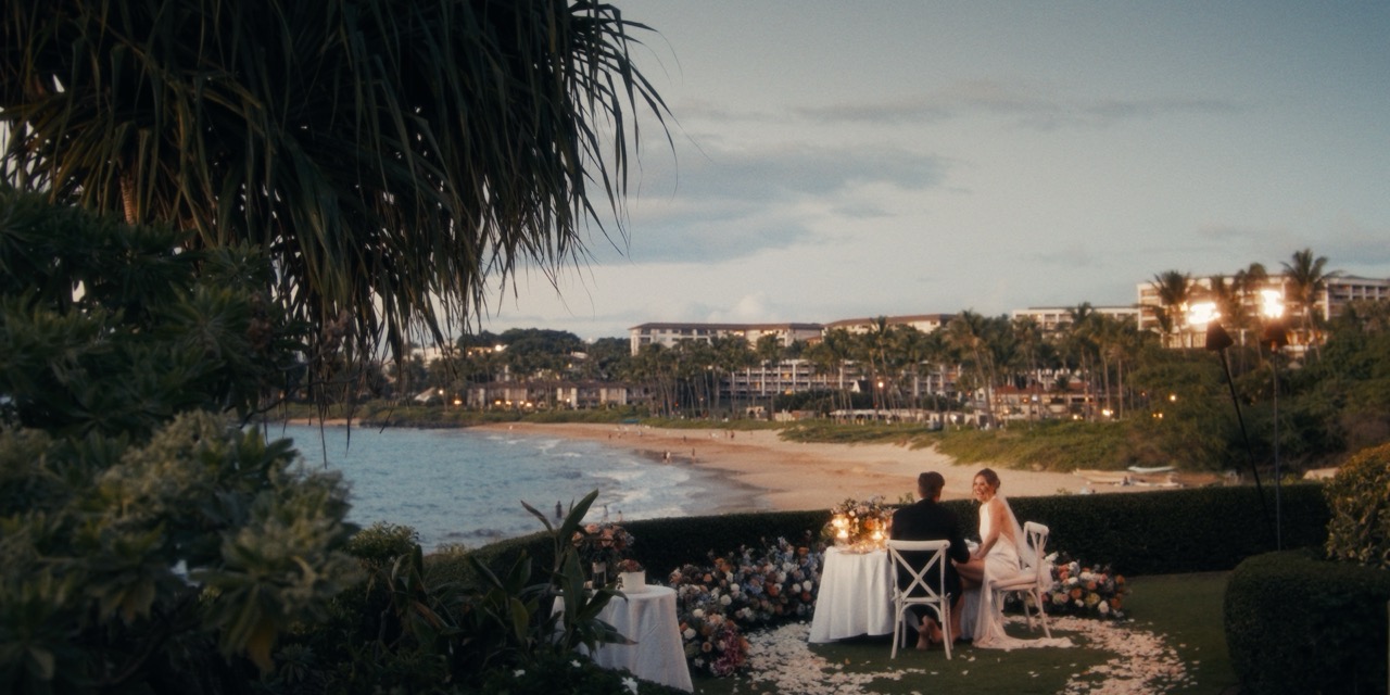 Newlyweds seated together at an intimate Wailea Point wedding dinner
