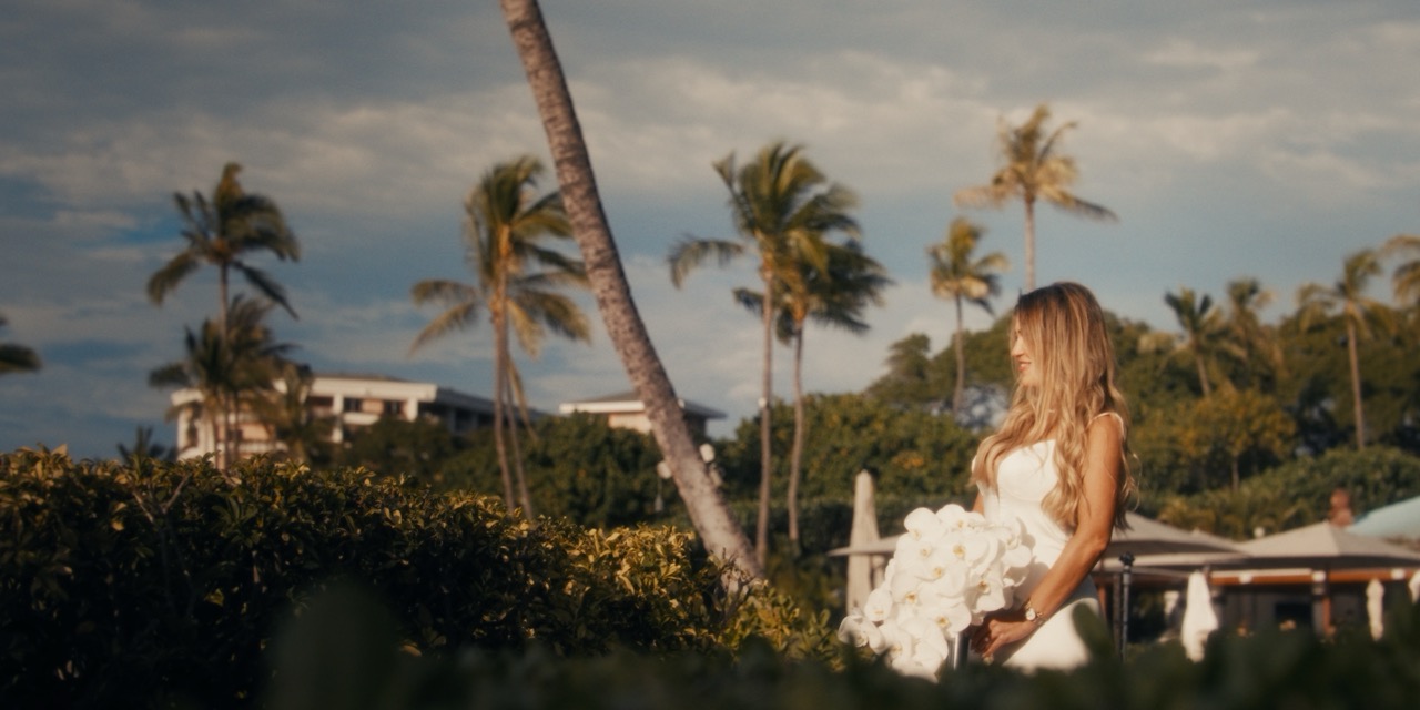 Bride framed by palms and warm evening light at Four Seasons Resort Maui