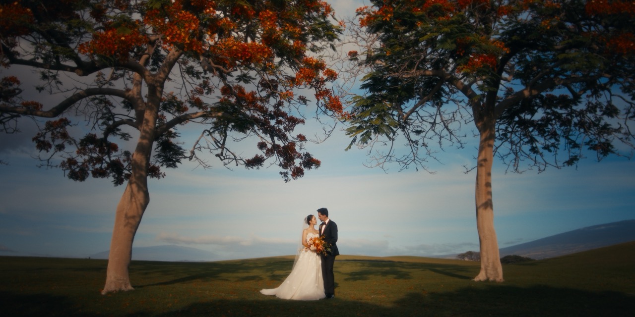 Jay and Tori laughing together during a windy oceanfront ceremony — Kapalua, Maui.