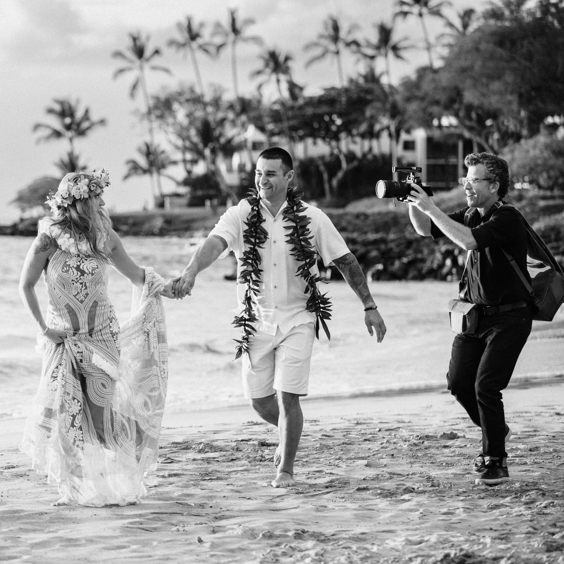 Stephan Boeker filming beside a newly married couple on Maui