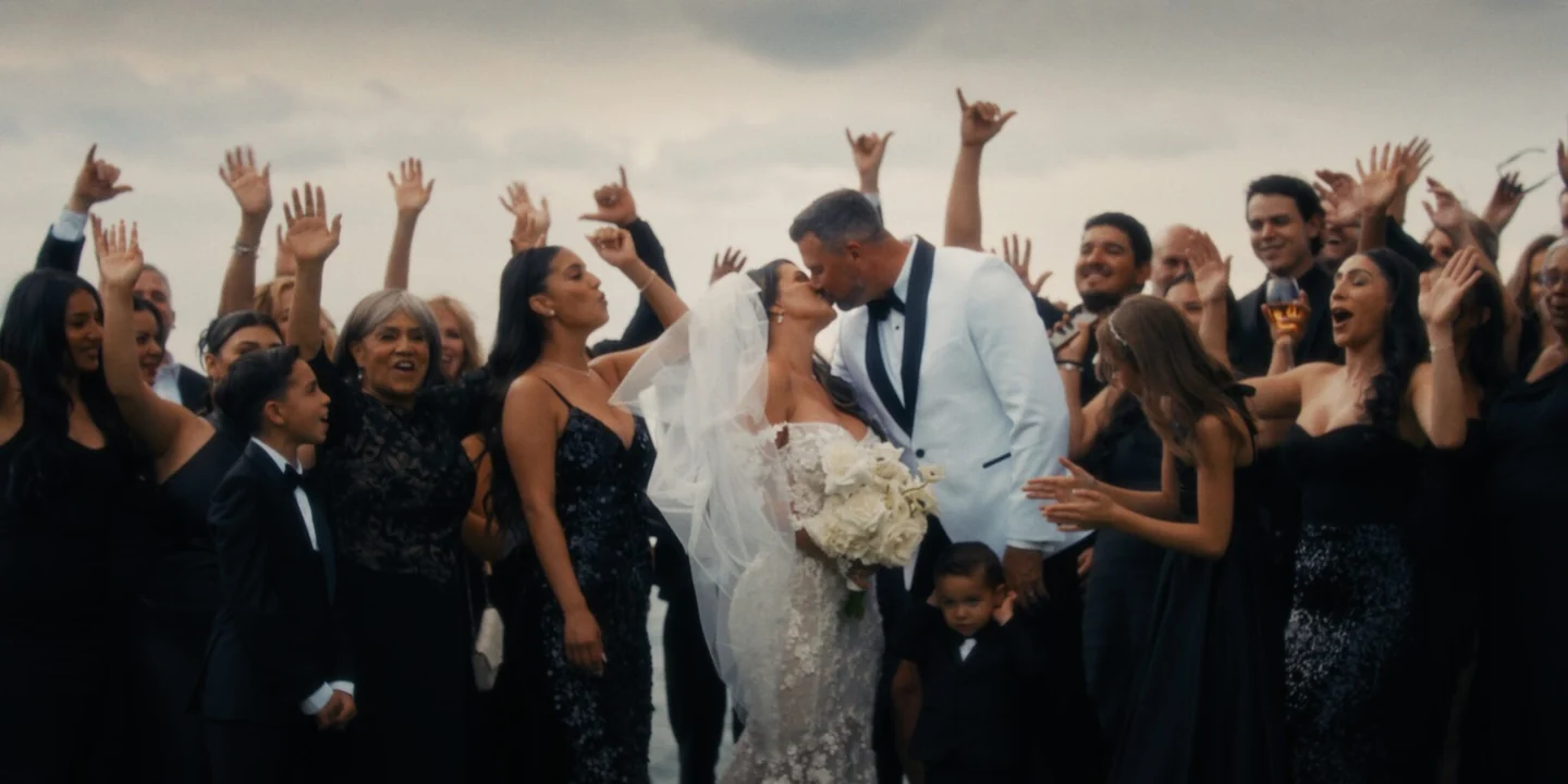 Michelle and Matthew celebrate at the center of a cheering group.
