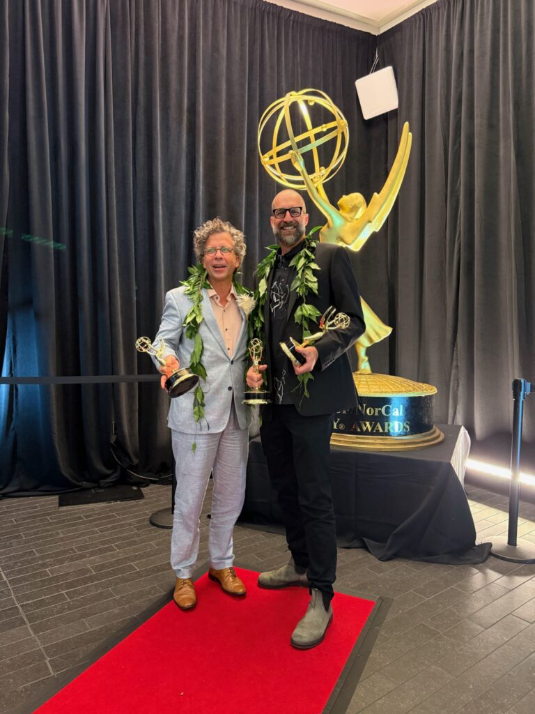 Stephan Boeker and David Sellers pose with Pacific Storytellers’ Emmy statuettes at the 2026 ceremony.