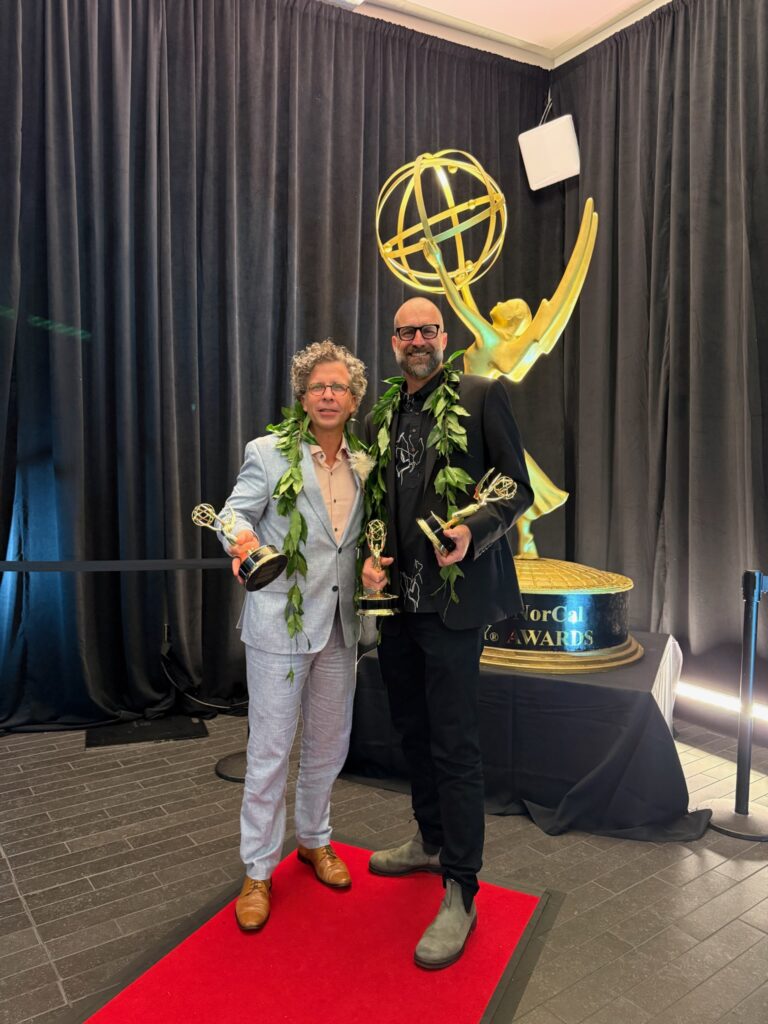 Stephan Boeker and David Sellers pose with Pacific Storytellers’ Emmy statuettes at the 2026 ceremony.
