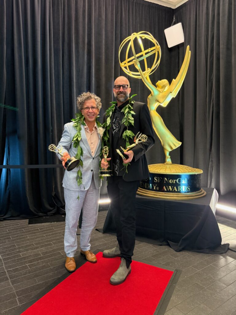 Stephan Boeker and David Sellers pose with Pacific Storytellers’ Emmy statuettes at the 2026 ceremony.