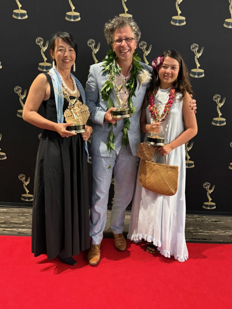 Stephan Boeker poses with Kazuko and Frida while the family holds Pacific Storytellers’ three Emmy statuettes.